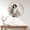 Floral penguin wall sign displayed above a console table in a bright wood-paneled entryway