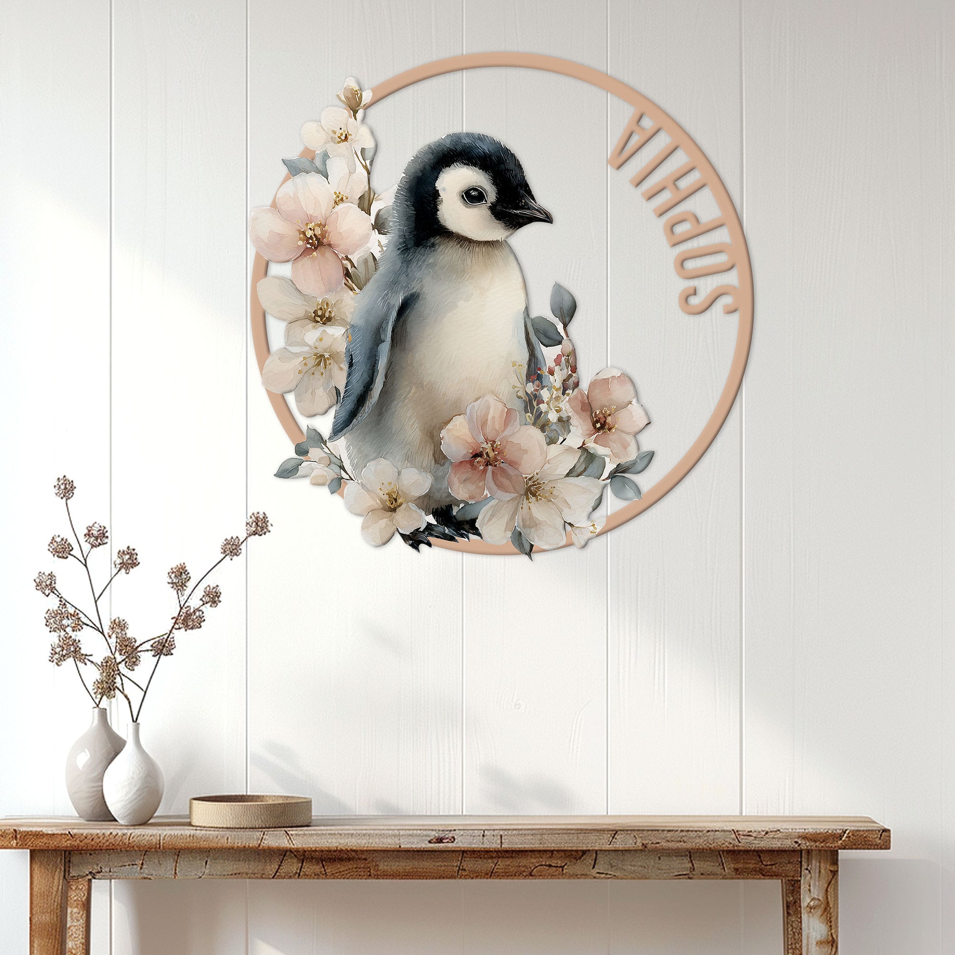 Floral penguin wall sign displayed above a console table in a bright wood-paneled entryway