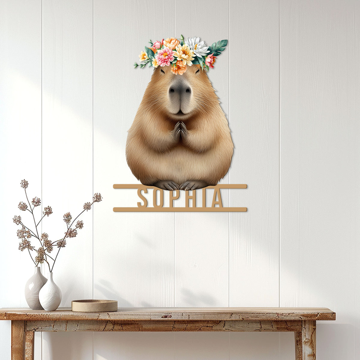 Floral capybara wall sign displayed above a rustic console table in a bright home interior