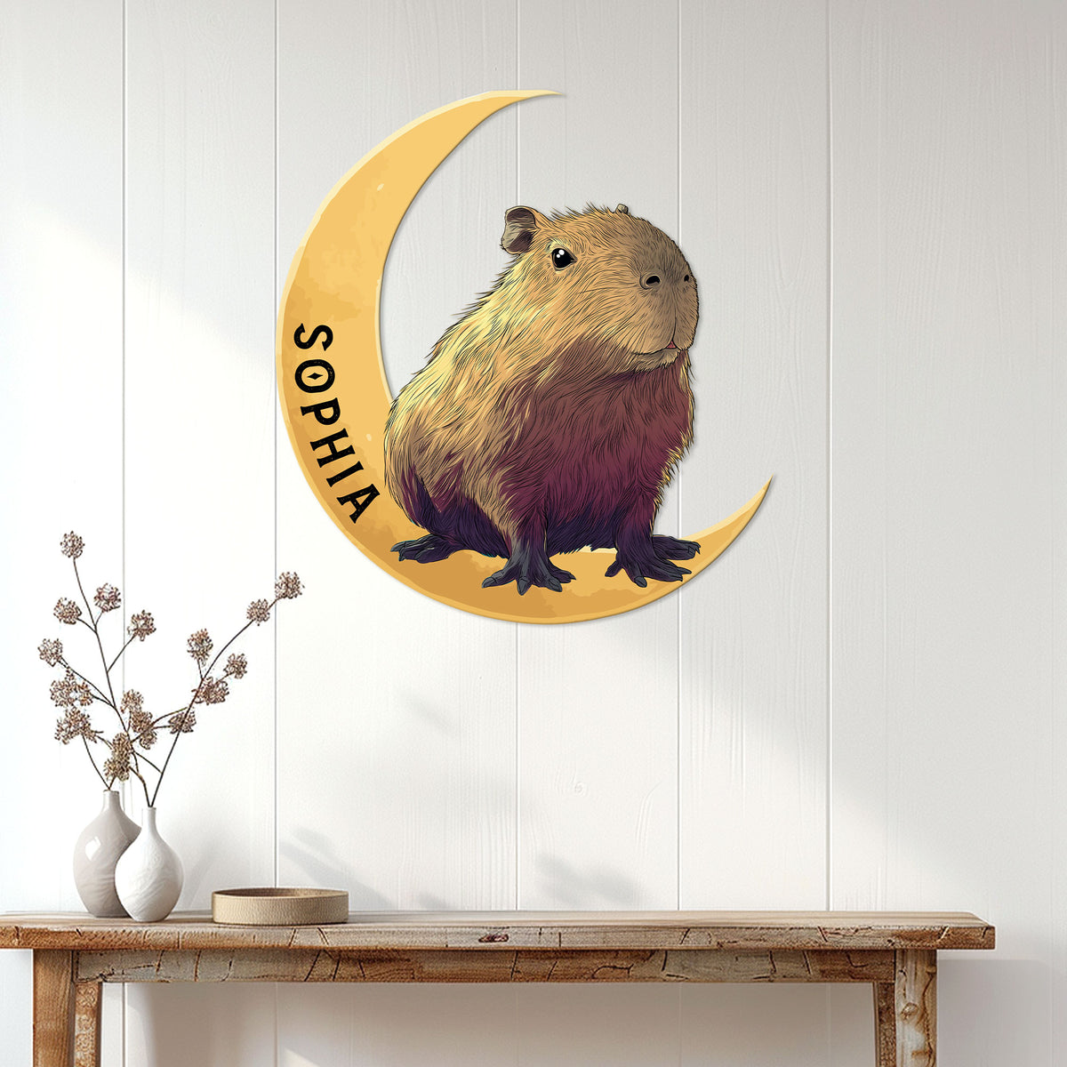 Capybara metal wall sign displayed above a console table in a bright home interior
