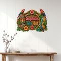 Tiki bar metal wall sign displayed on a light wood-paneled wall above a console table