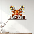 Reindeer Christmas metal sign displayed on a white paneled wall in a bright home