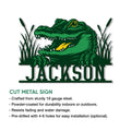 Cut metal alligator sign shown with a bold green swamp alligator design and decorative marsh grass