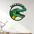 Green alligator wall sign displayed on a bright paneled interior wall