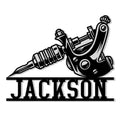 Black-and-white tattoo machine artwork on a custom metal sign for tattoo artist studio decor