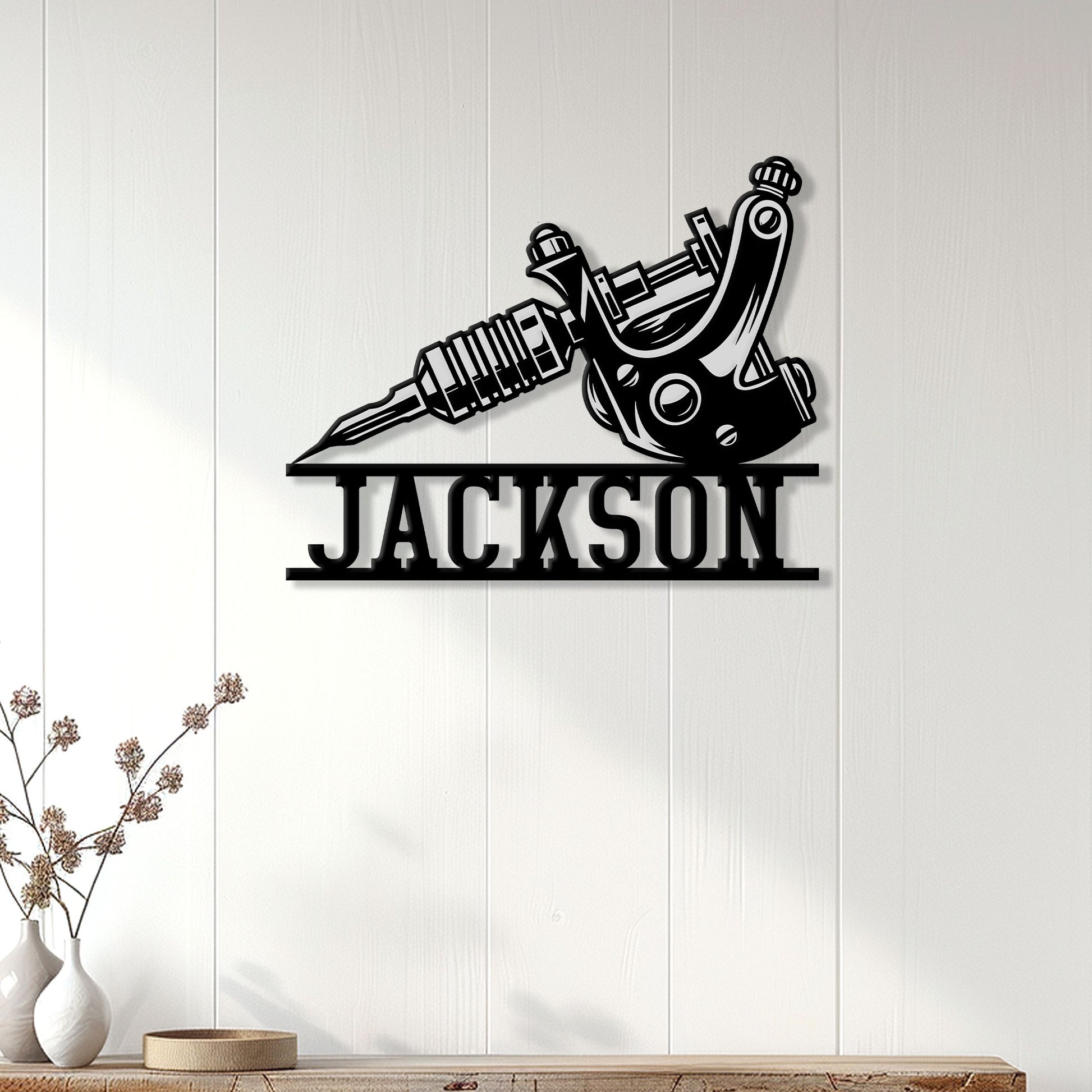 Tattoo machine metal wall sign displayed on a bright paneled wall as tattoo studio decor