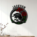 Tattoo machine and roses metal sign displayed as wall decor on a bright paneled wall