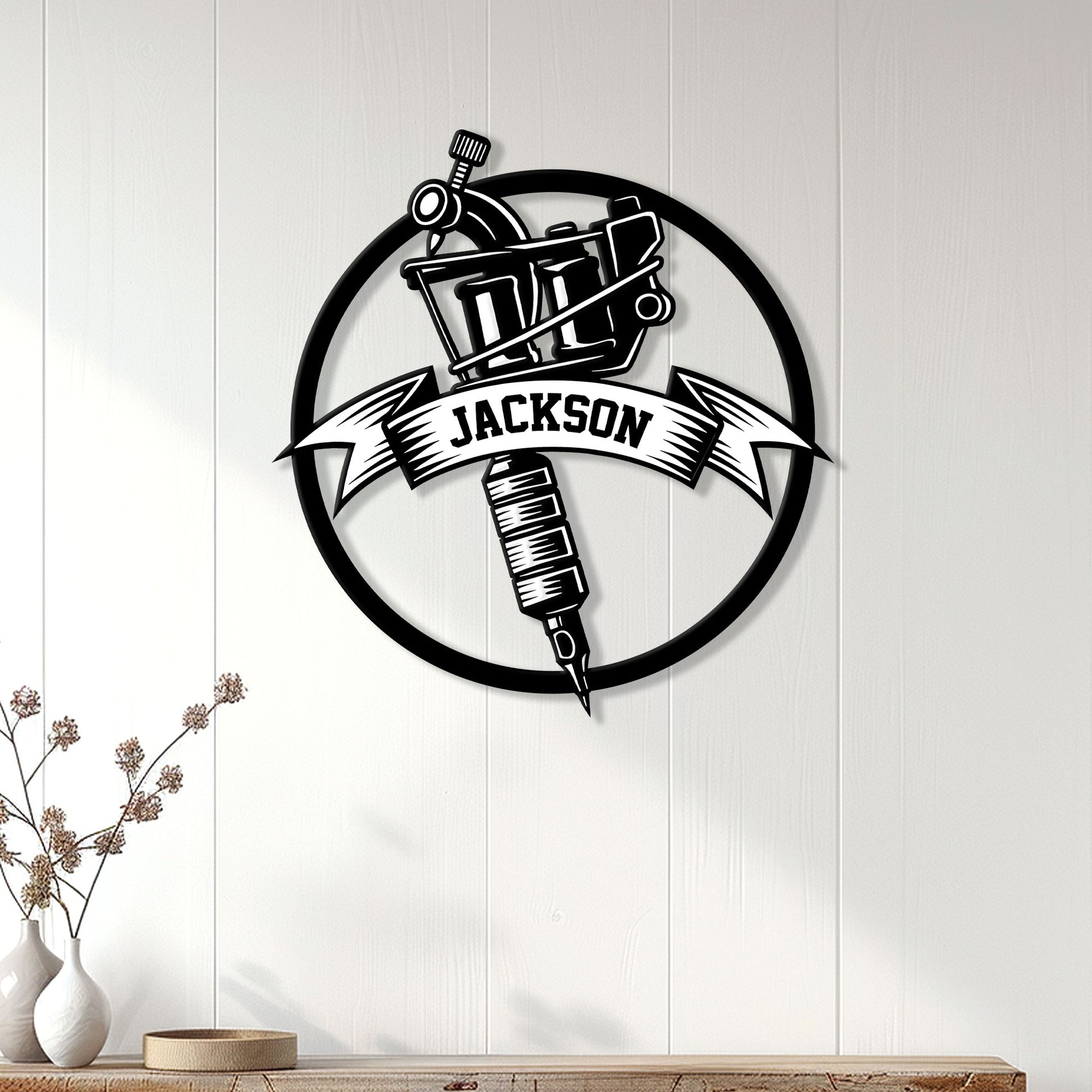 Tattoo studio wall decor featuring a black tattoo machine sign displayed on a light wood-paneled wall
