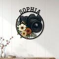 Photographer wall sign displayed on a light wood-paneled wall above a modern console