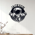 Astronaut wall sign displayed on white paneled decor for a modern space-themed room