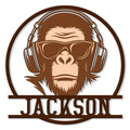 Stylized monkey wearing headphones and sunglasses in a circular custom metal sign design