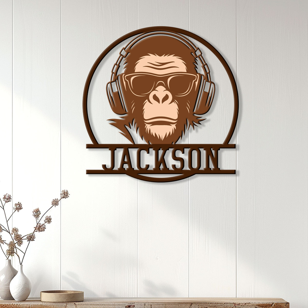Custom monkey wall sign displayed on a light wood-paneled wall in a modern living space