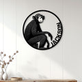 Monkey metal wall sign displayed on a white paneled wall above a console table