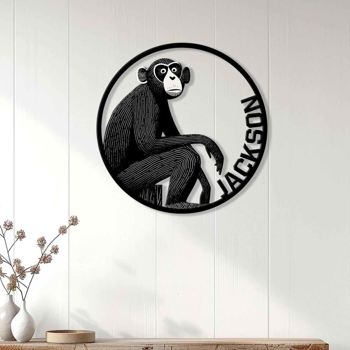Monkey metal wall sign displayed on a white paneled wall above a console table
