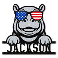 Patriotic hippo metal sign featuring American flag sunglasses and a playful raised-paw design