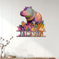 Colorful floral hippo metal wall sign displayed above a modern wood console
