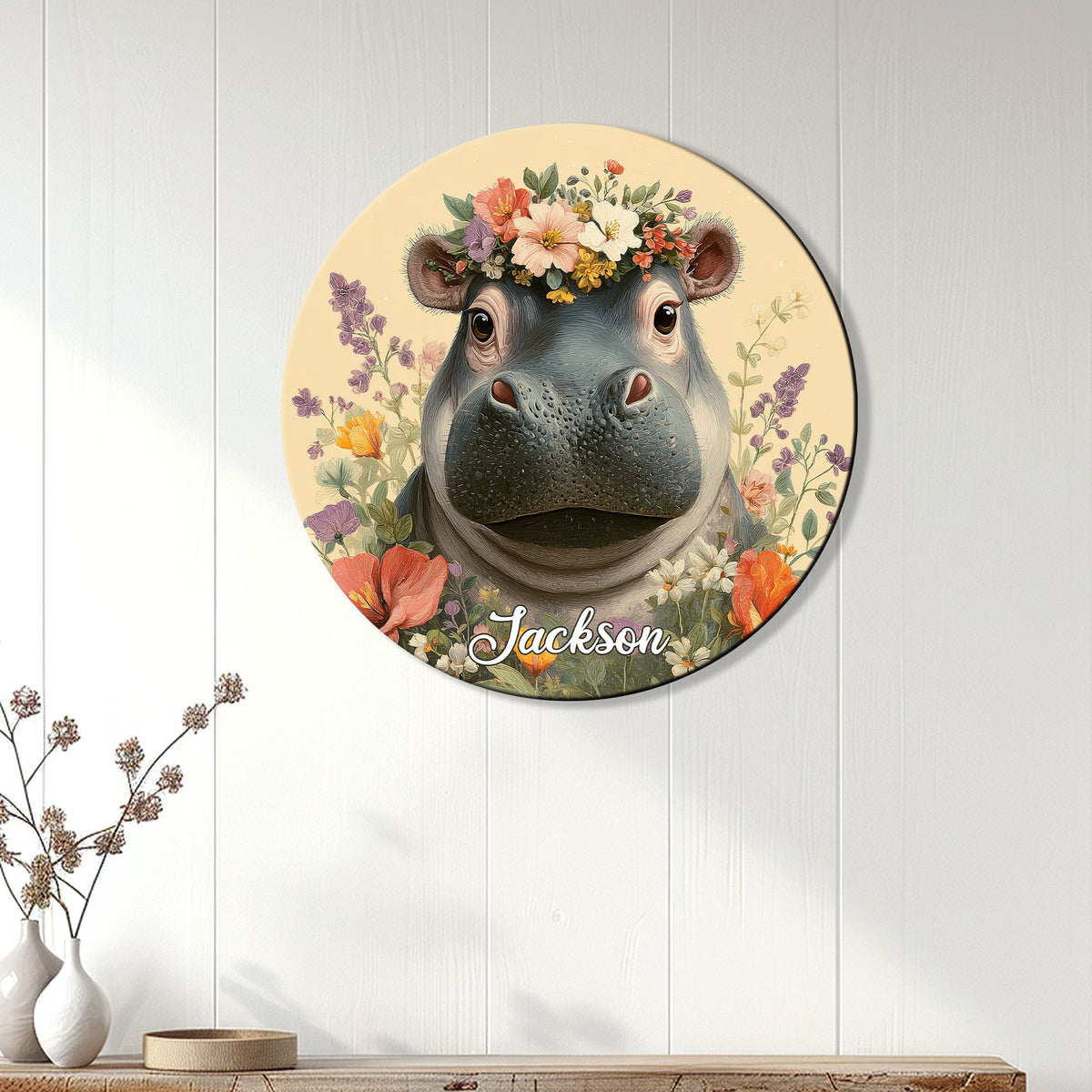 Round floral hippopotamus wall sign displayed on a light paneled wall above a console table