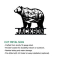 Cut metal bear sign with a scenic mountain, forest, river, and moon design shown in a product feature graphic