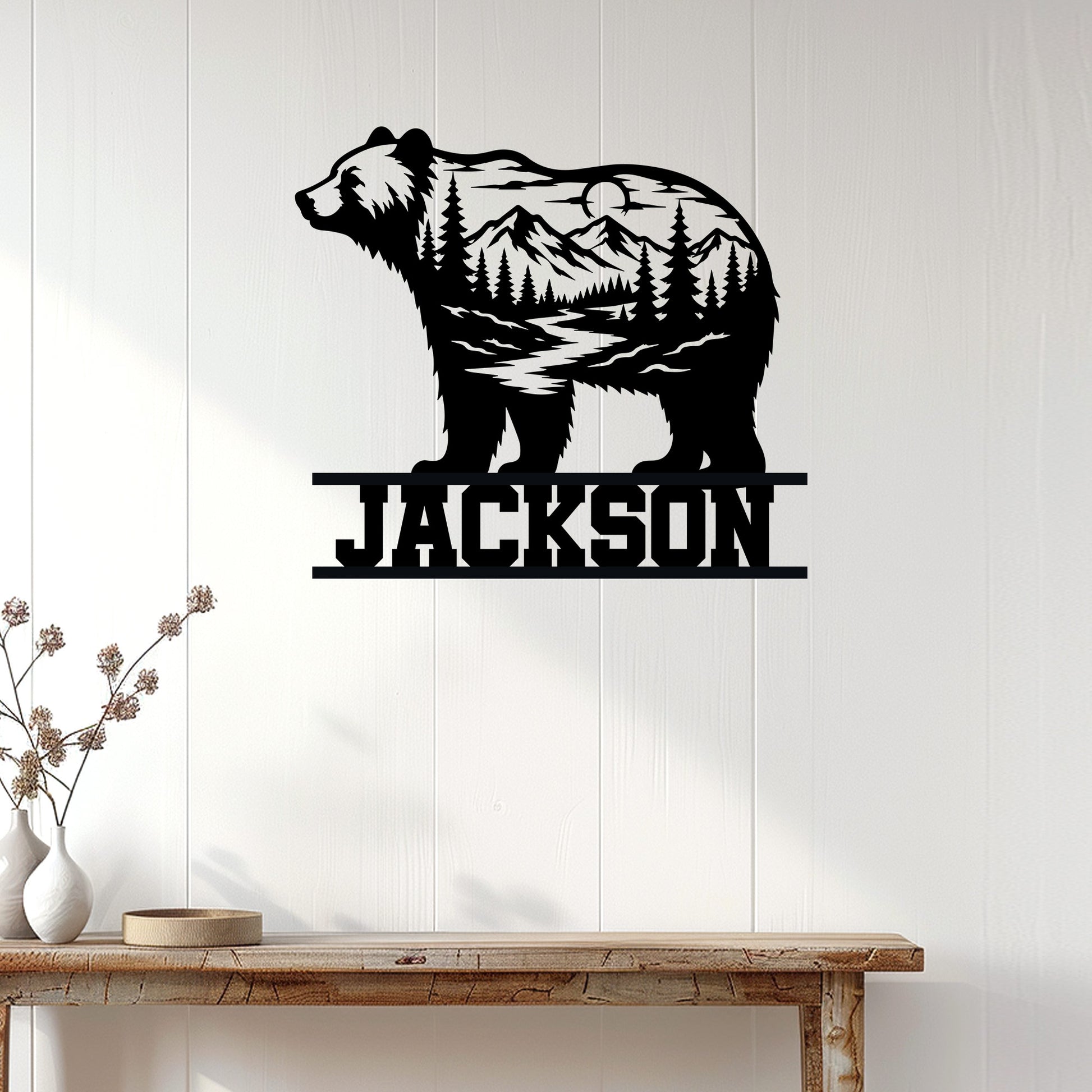 Bear silhouette metal wall sign displayed on a light wood-paneled wall above a rustic console table