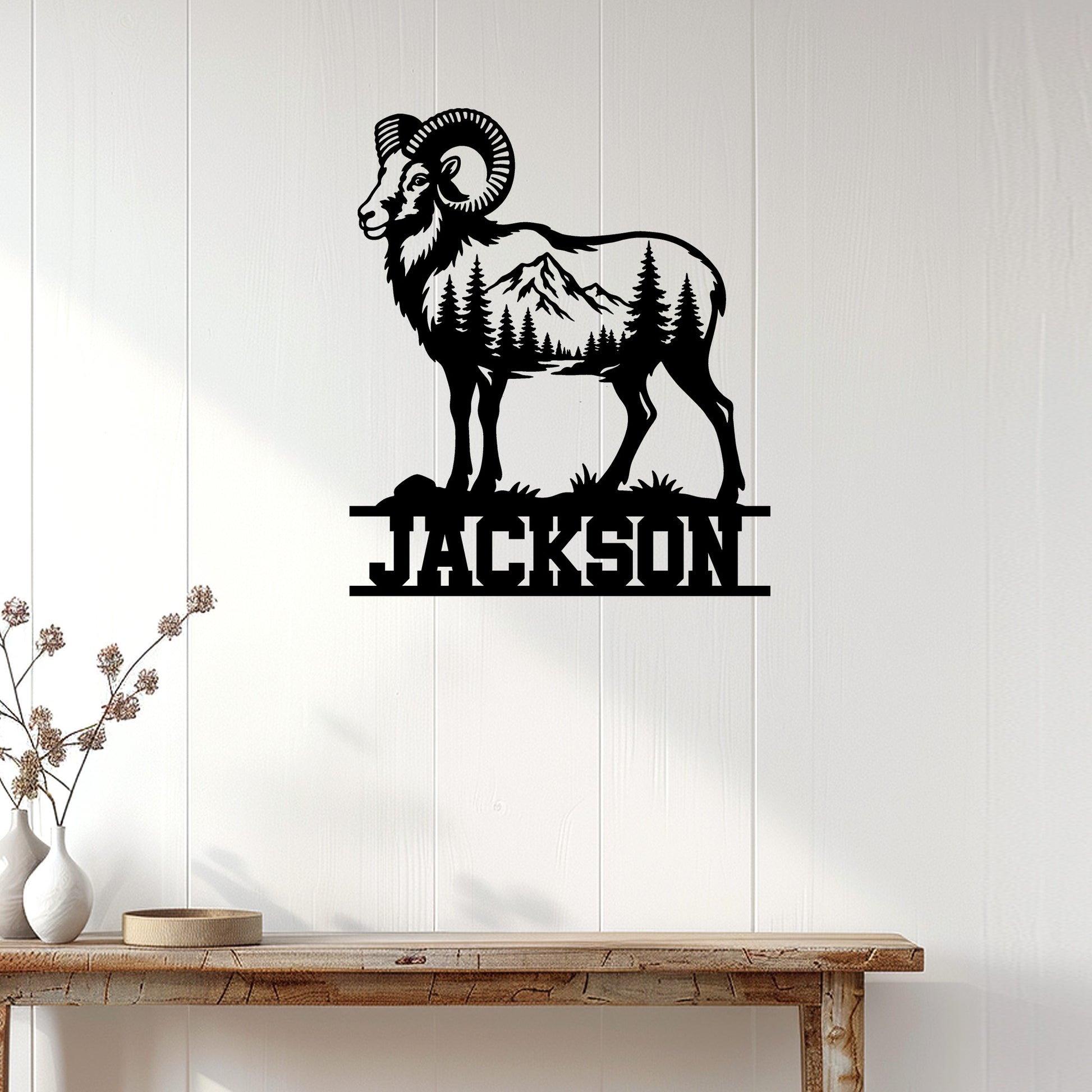 Bighorn sheep wall sign displayed on a light wood-paneled wall above a console table