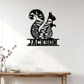 Squirrel metal wall sign displayed on white wood paneling above a rustic console table