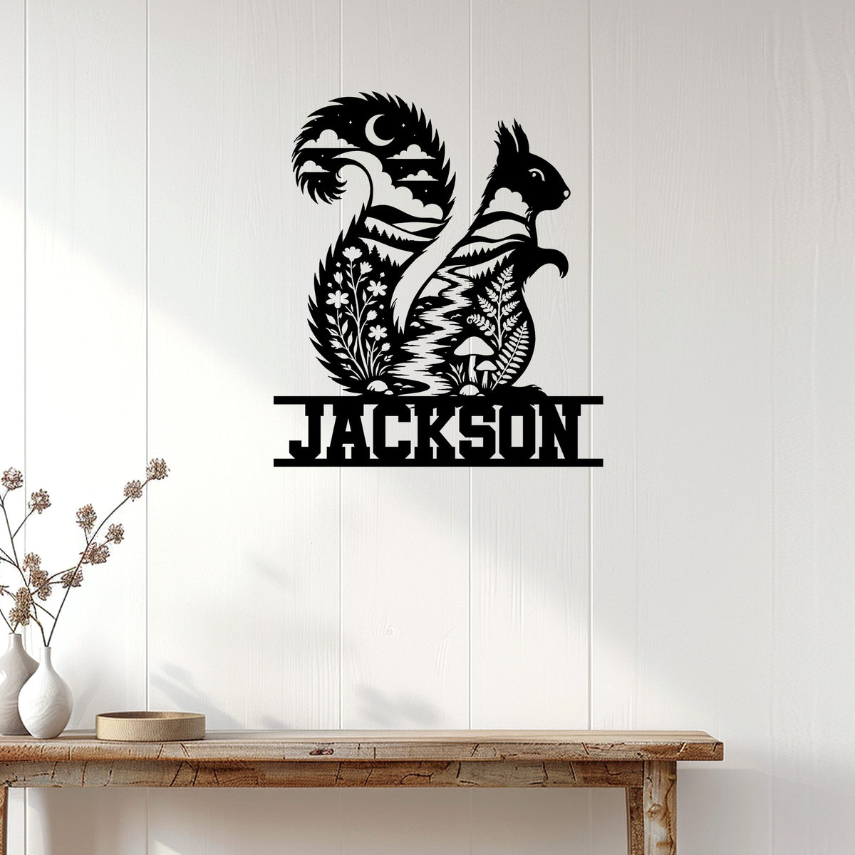 Squirrel metal wall sign displayed on white wood paneling above a rustic console table