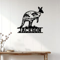 Kangaroo metal wall decor displayed on a white paneled wall above a rustic console table