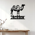 Camel wall sign displayed on a light wood-paneled wall above a console table