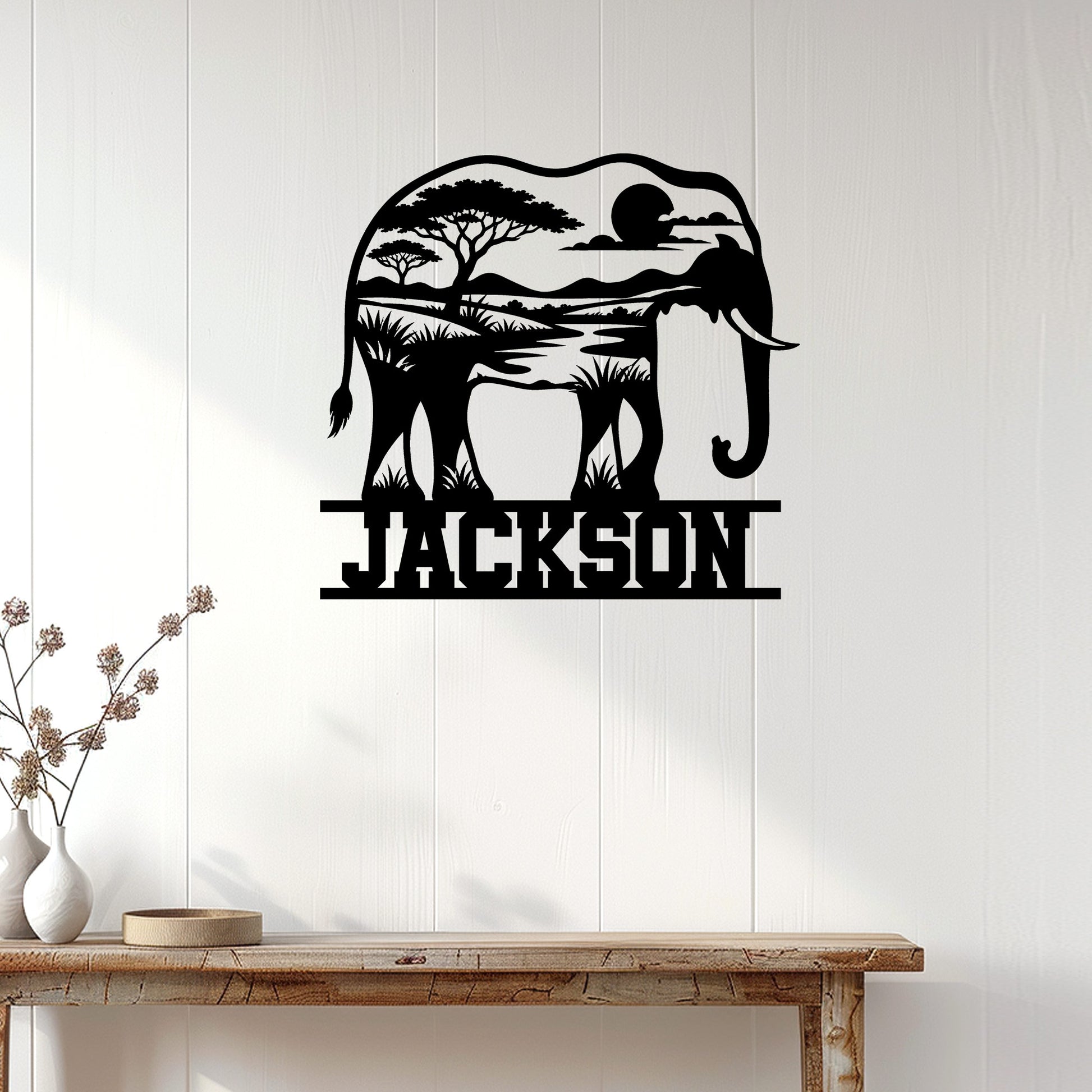Elephant wall sign displayed on a white paneled wall above a rustic console table