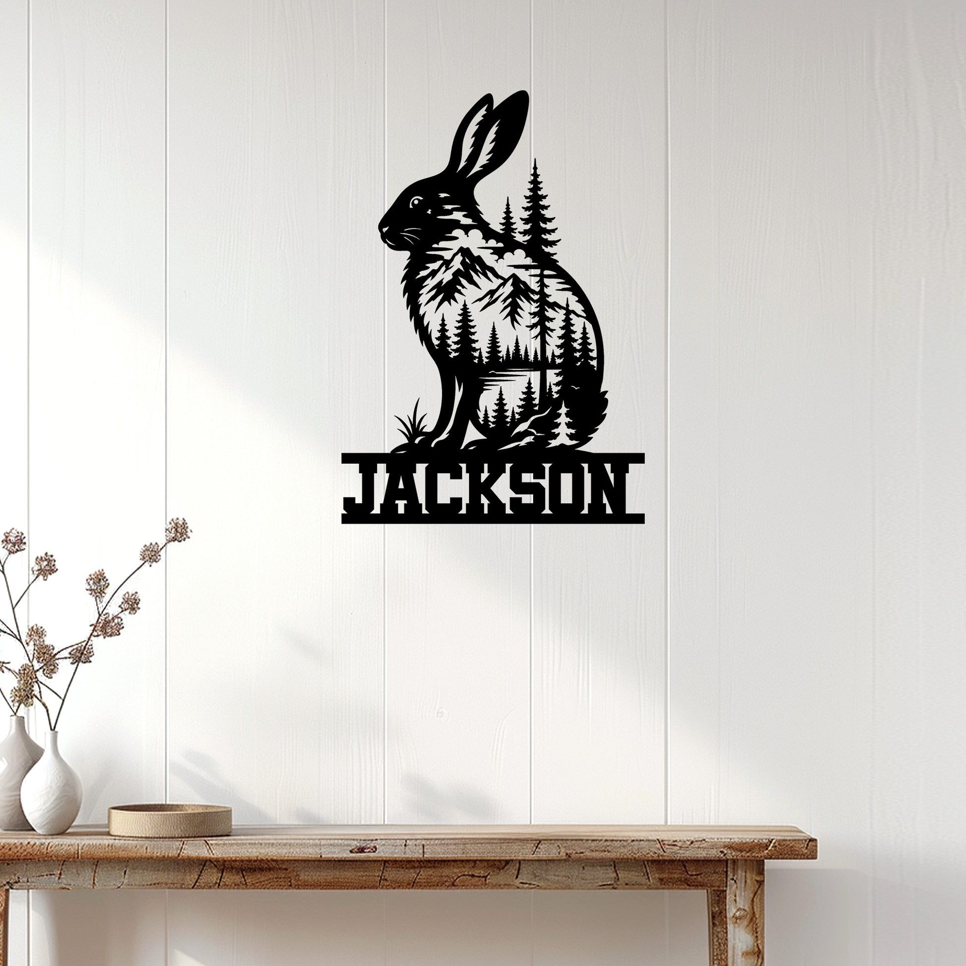 Rabbit and mountain forest metal sign displayed as nature-inspired wall decor in a bright home