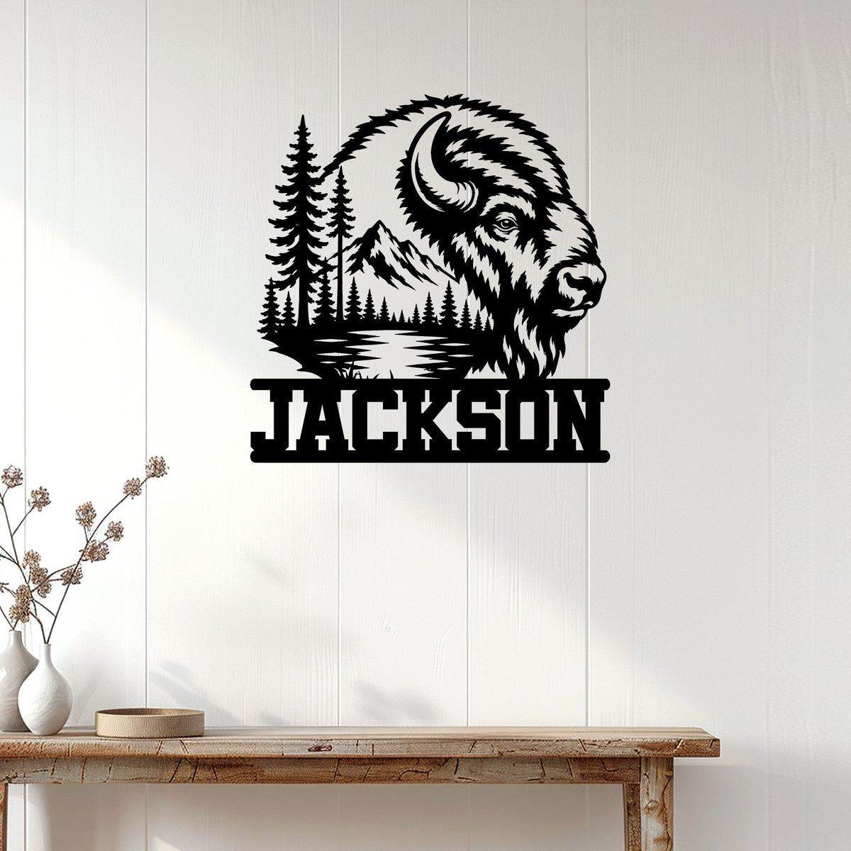 Bison wall sign displayed on white wood paneling above a rustic console table in a modern home