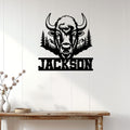 Rustic bison metal wall sign displayed on a light wood-paneled wall above a console table