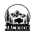 Custom bison metal sign featuring a mountain wilderness scene with pine trees and a bold buffalo silhouette