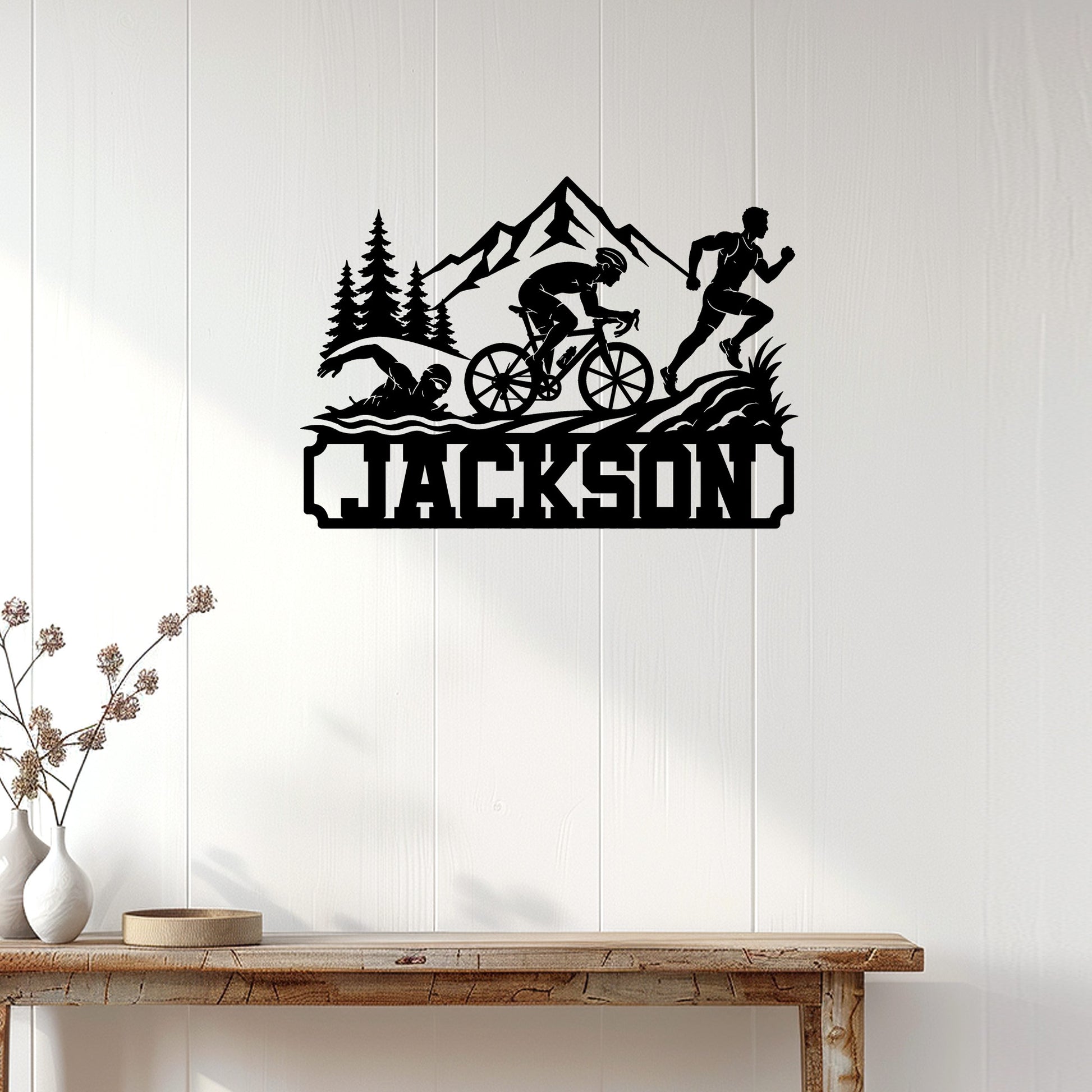 Triathlon wall decor displayed on a light wood-paneled wall above a console table