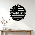Black American flag garage metal sign displayed on a white paneled wall above a wood console