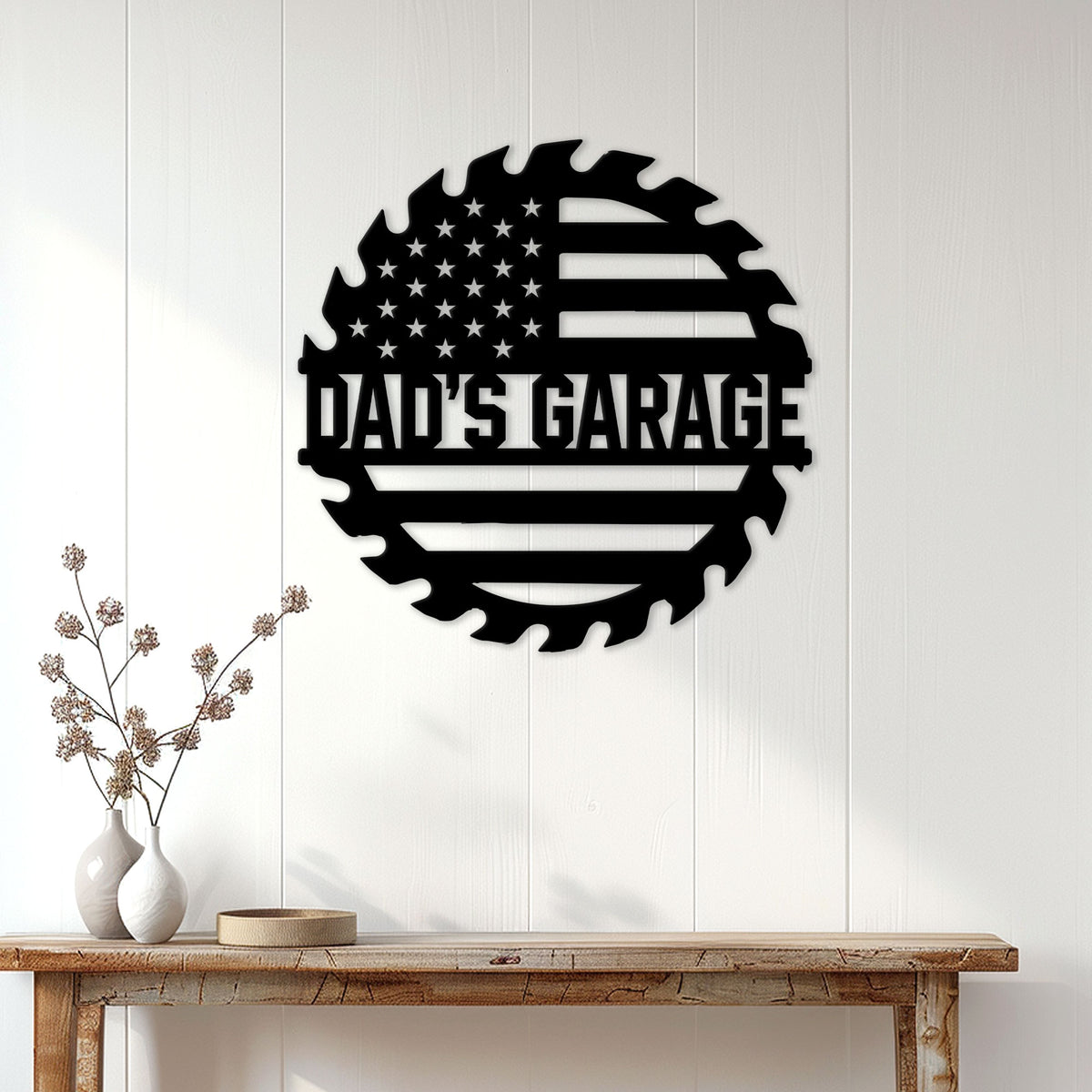 Black American flag garage metal sign displayed on a white paneled wall above a wood console