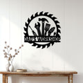 Black Dad's Workshop metal sign displayed on a white paneled wall above a rustic wood console