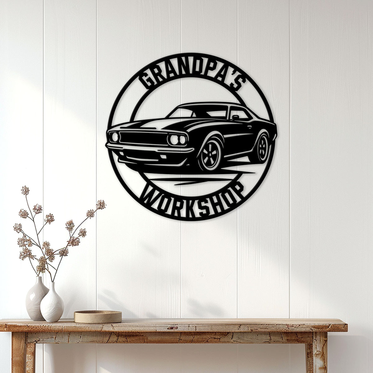 Classic car workshop wall sign displayed on a white paneled wall above a rustic console