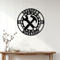 Black workshop wall sign displayed above a console table in a bright home interior