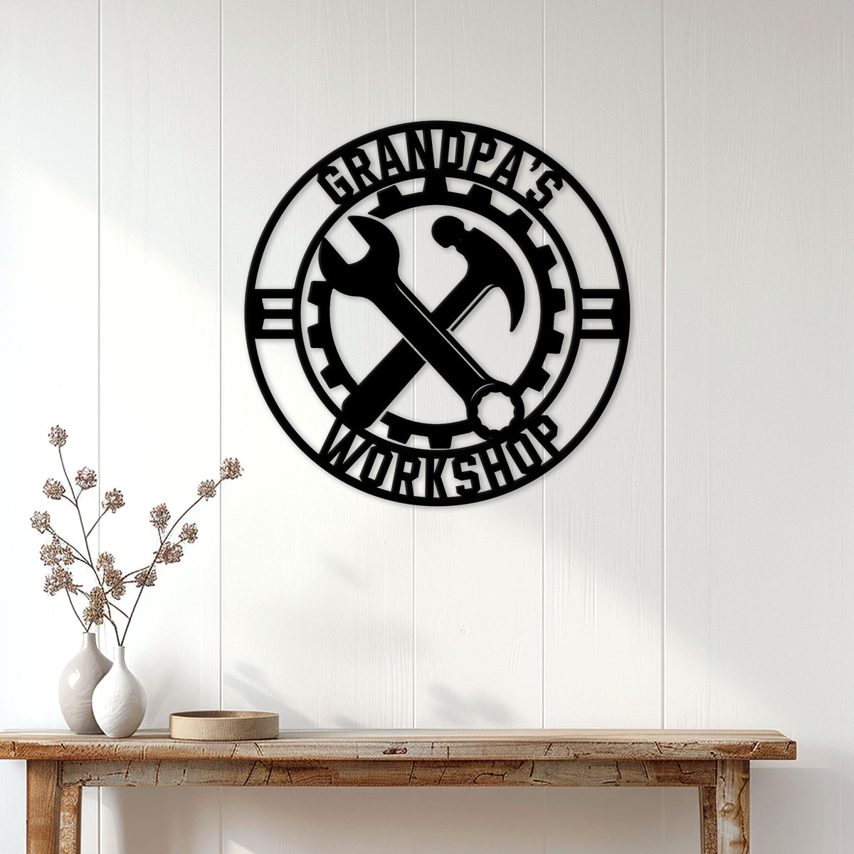 Black workshop wall sign displayed above a console table in a bright home interior