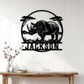 Black rhino metal wall sign displayed above a console table in a bright home interior