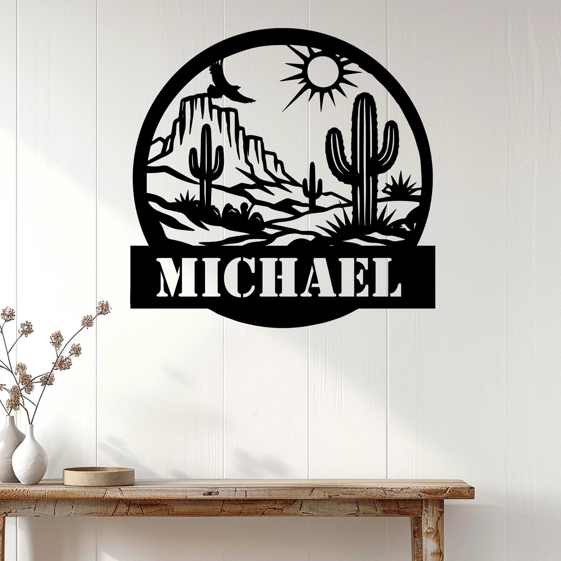 Cactus desert metal wall sign displayed on white paneling above a rustic console table