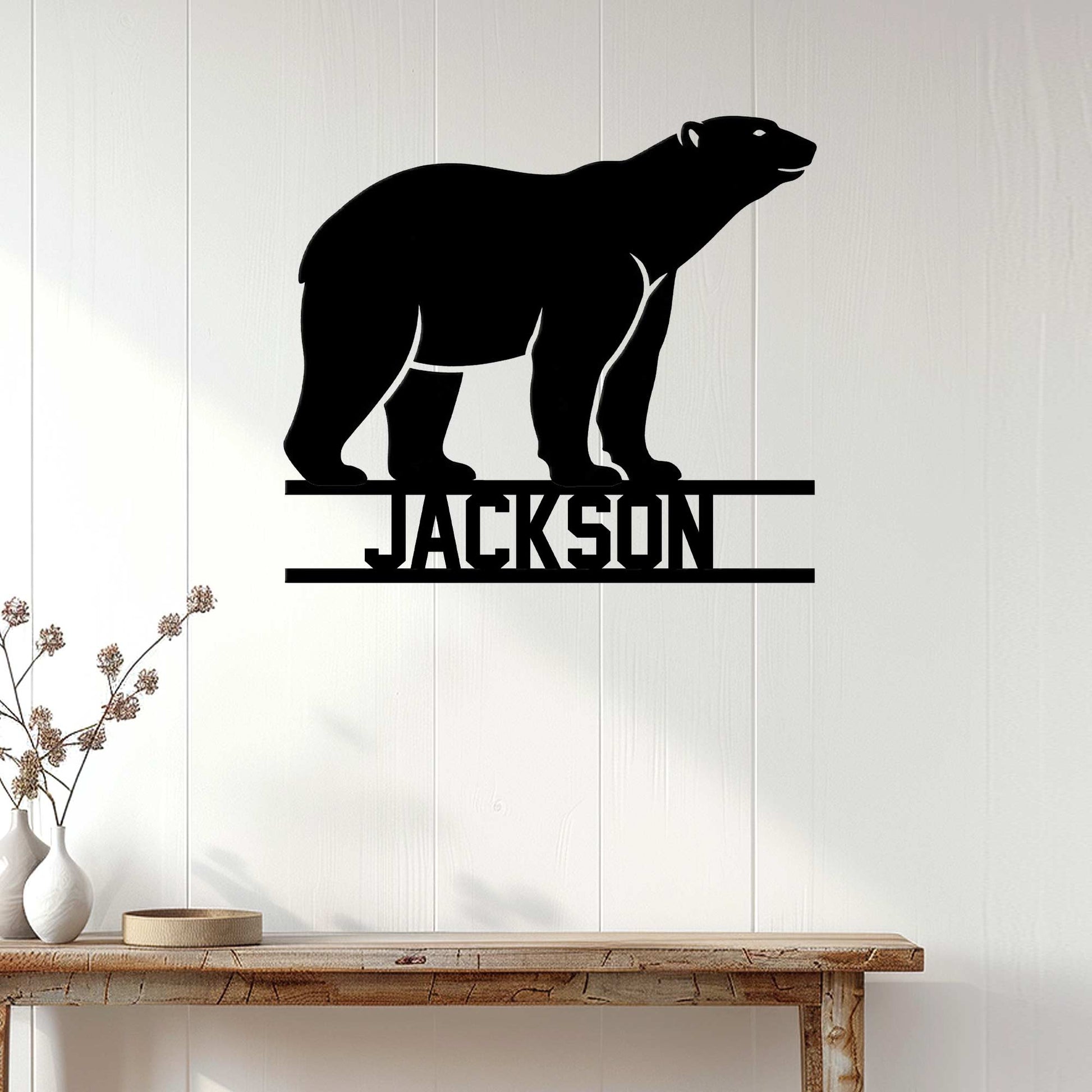 Polar bear silhouette metal sign displayed on a bright paneled wall in a modern home