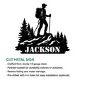 Trekking metal sign feature graphic showing a backpacking hiker silhouette among mountain trees