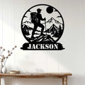 Hiking metal sign displayed on a white wood wall, featuring a mountain trekker and forest landscape