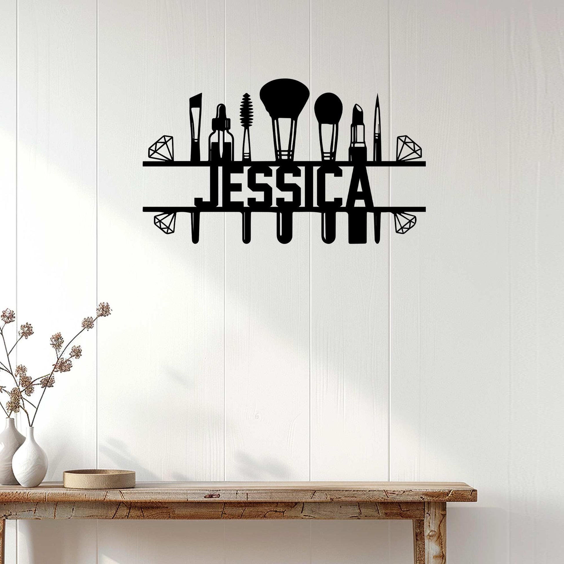 Black makeup artist wall sign displayed on a light wood-paneled wall above a console table