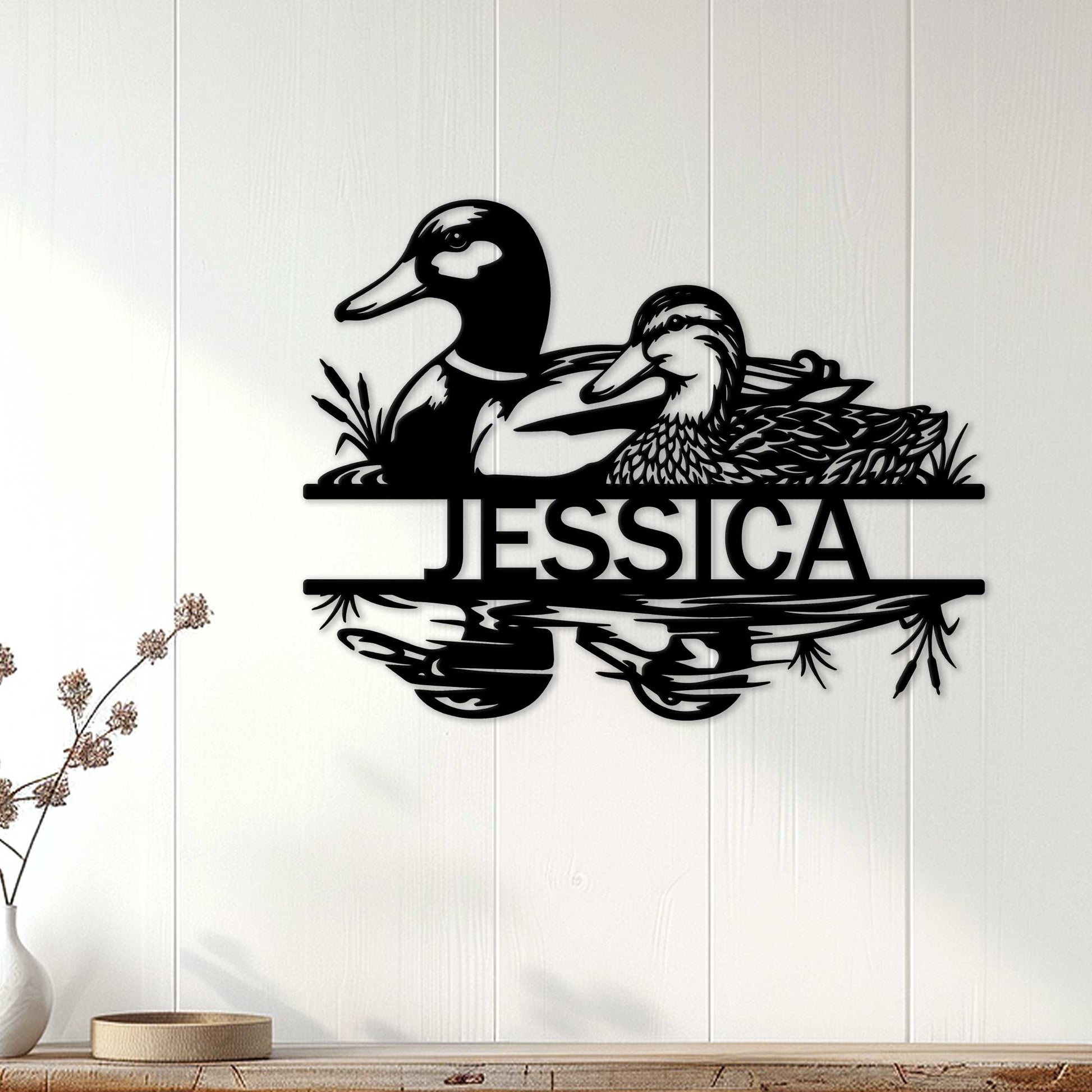 Black duck wall sign displayed on a light wood-paneled wall in a home decor setting