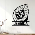 Ladybug wall sign displayed on a light wood-paneled wall as nature-inspired home decor