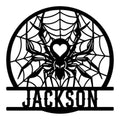 Black metal spider sign featuring a detailed spider web, central heart motif, and bold circular design