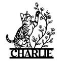 Black tabby cat metal sign with raised paw, floral branches, and a bold custom lower design